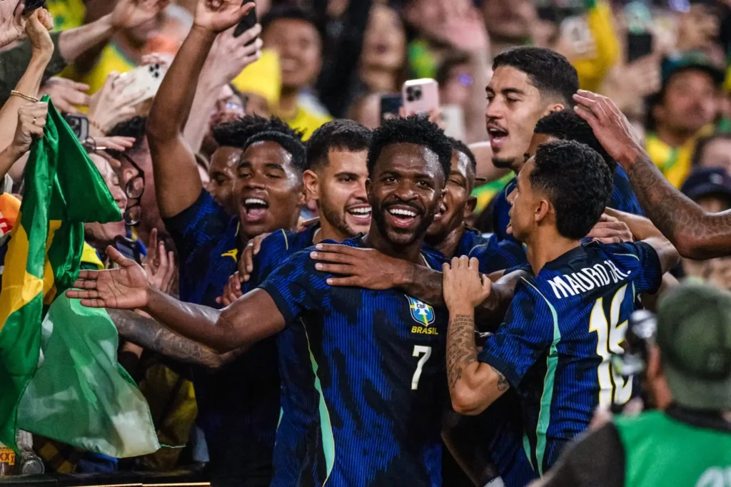 Vinicius y jugadores de Brasil celebran abrazados junto a los aficionados el triunfo ante Australia.